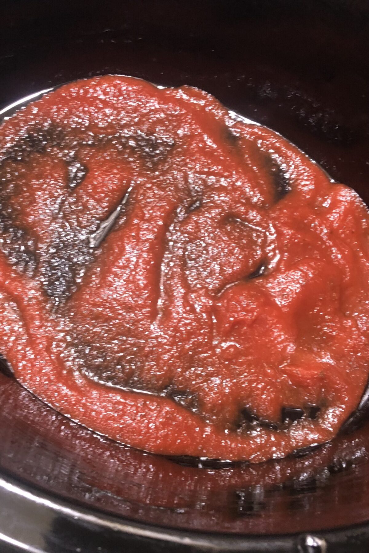 Putting a layer of sauce in the bottom of the pan for cooking zucchini lasagna