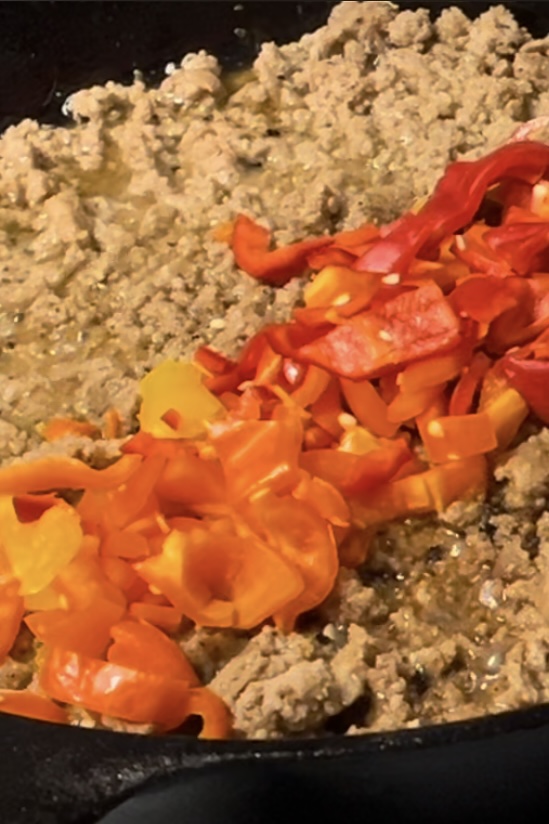 Meet and peppers in the pan the peppers o. Top a have a nice bright color all in a line