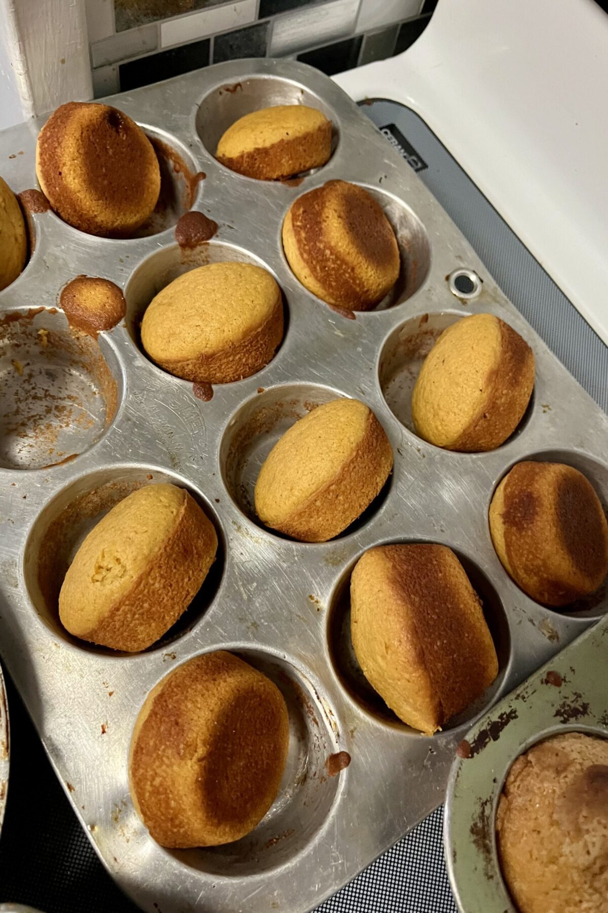 Pumpkin muffins are still in the pan they’ve been pops out or just kind of whatever way that they came out still on the pan. They have a nice dark color where the tops has a nice light brown color.
