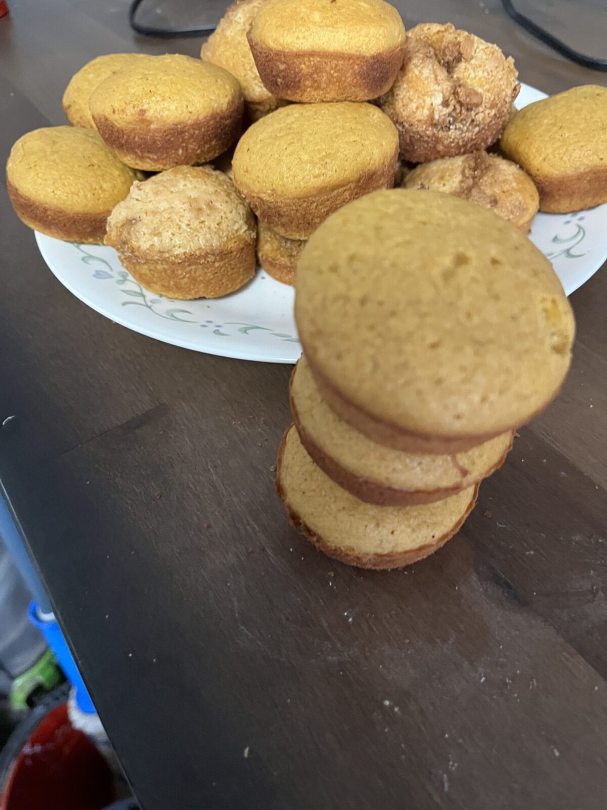 There’s a sack of three muffins sitting on top of each other next to the point where the muffins are all on a plate ready to be served