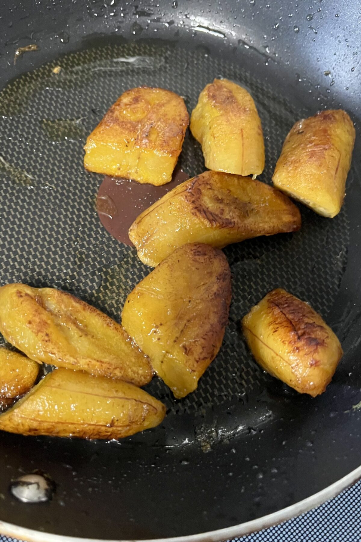 Some plantains cooking and frying pan eating a nice and gold then to get some extra flavor out of them almost about them