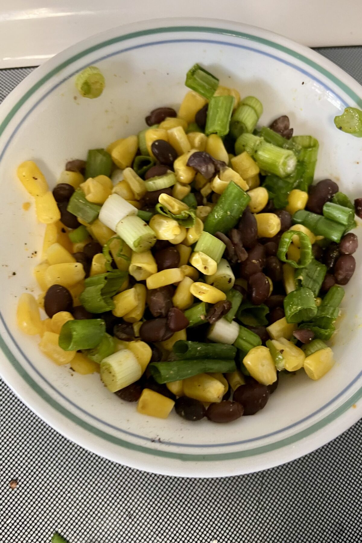 is the corn bean next year till I have some additional color and flavor to the dish beans have been washed and added recommend roasting the corn help give her a little bit of extra flavor. You can see the green part of the green onions already been added in as well And just all mixed together.