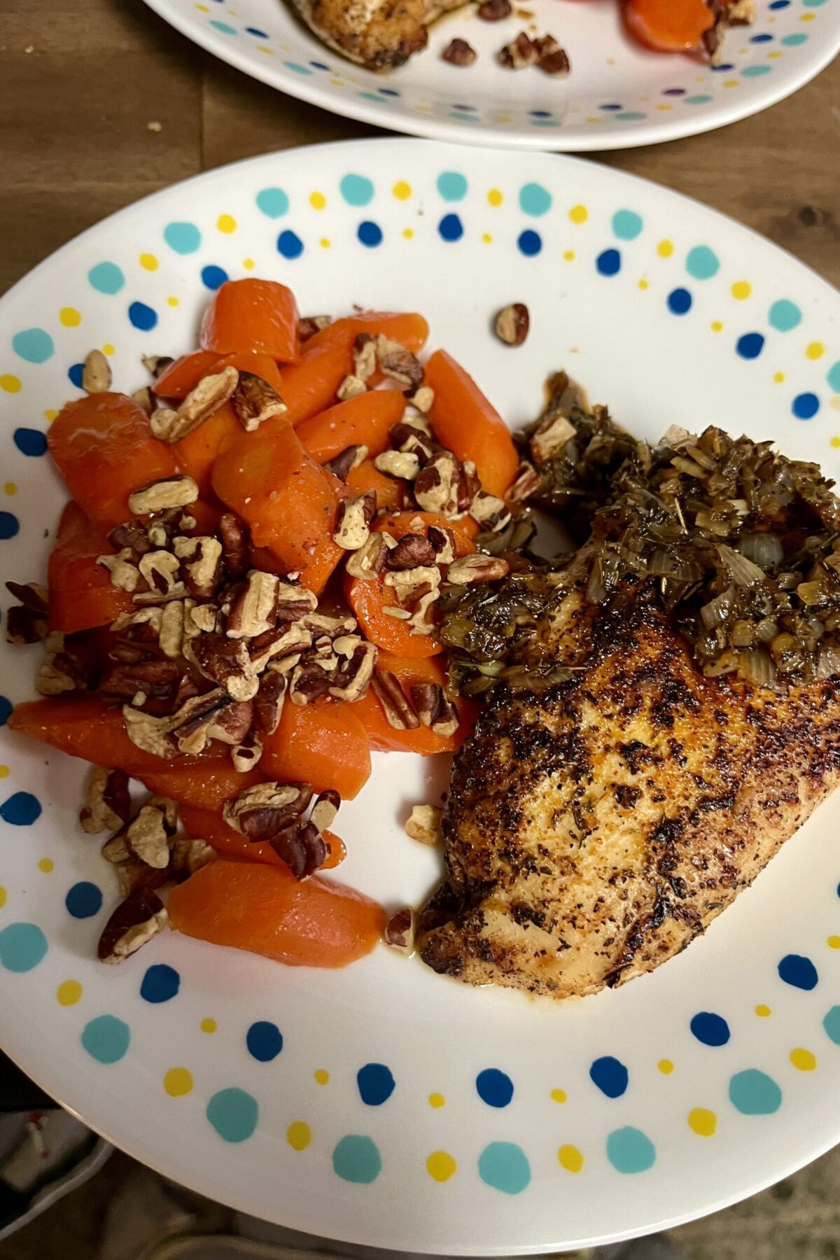 Nice seasoned chicken on the right with shallots that are browned. Pecans on carrots nice bright orange