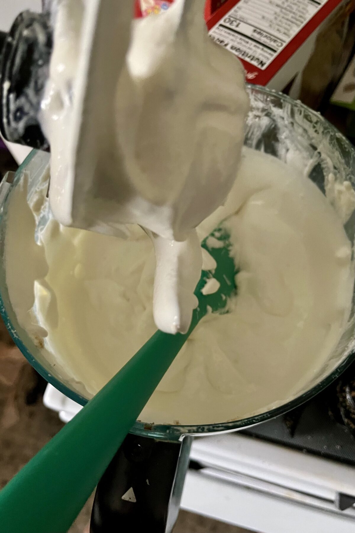 Whipped cream and cream cheese have been mixed together and ready to pure pretzels