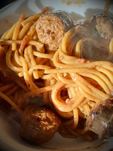 Square image of the pasta dish didn’t see the steam coming off of it has a nice red orange color of sausage in it as well