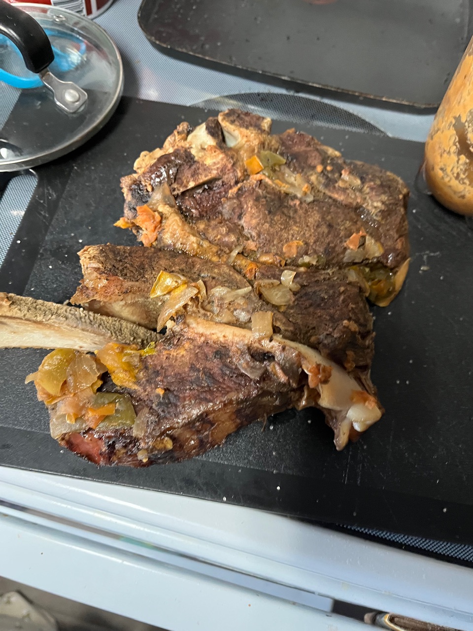 House has been pulled out of the car bar and ME slides you can see the pulling off of the bone and still some of the onions and garlic on it