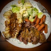 There is a square image has been made out of the juices and placed on top also a little bit of the chili sauce has been added on top of the roast baby as well with dark on the whiteness of the potatoes