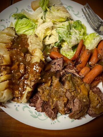 There is a square image has been made out of the juices and placed on top also a little bit of the chili sauce has been added on top of the roast baby as well with dark on the whiteness of the potatoes