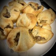 Plate has been feels with sausage gravy crescent rolls they have a nice golden to St on the rolls see little bits of gravy sticking out