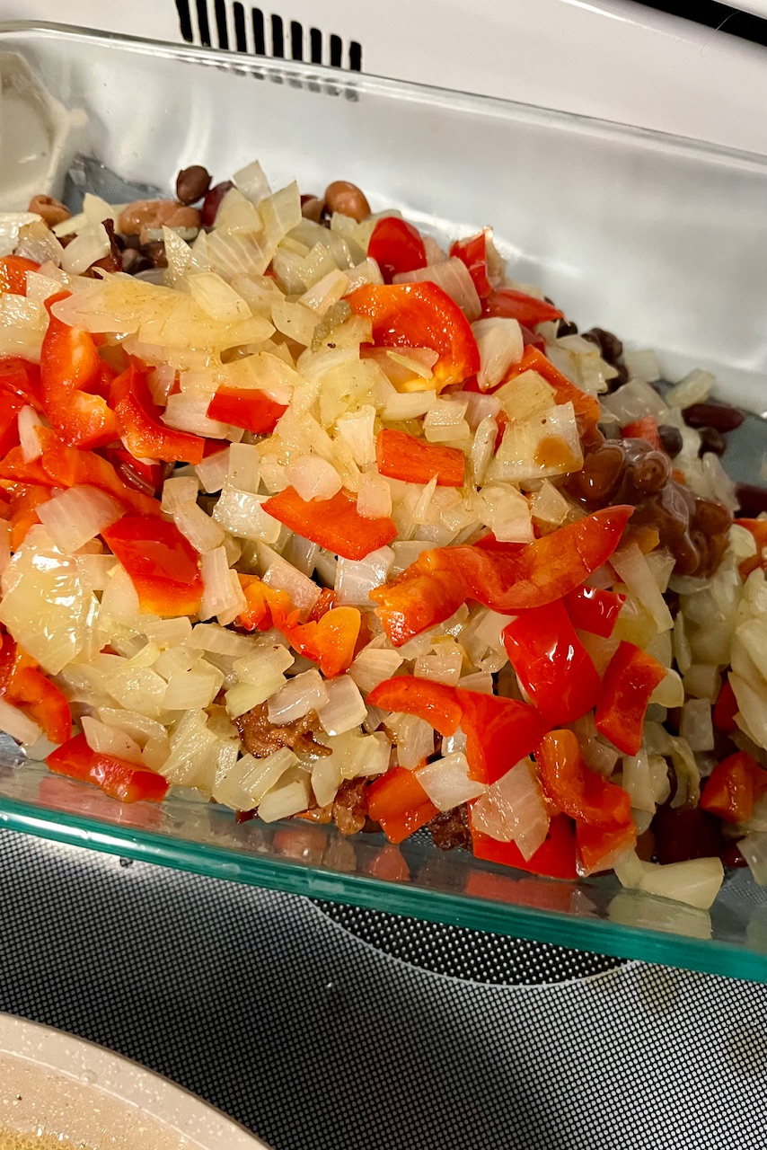 You can see a pill of onions and bell pepper mixed in a bowl