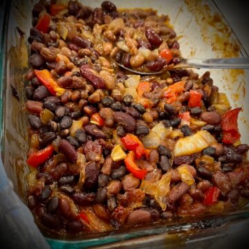 You can see a pan full of beans peppers and onions