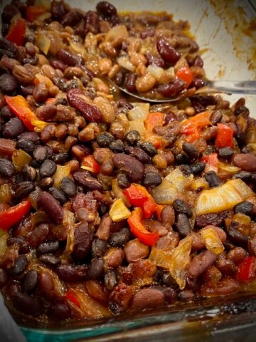 You can see a pan full of beans peppers and onions