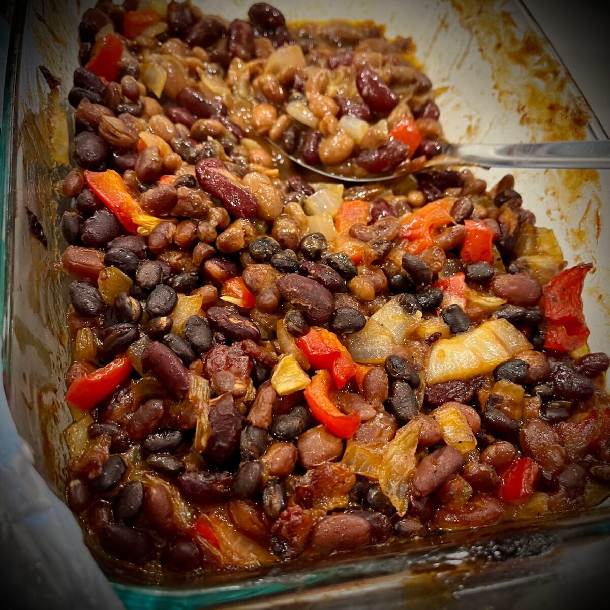 You can see a pan full of beans peppers and onions
