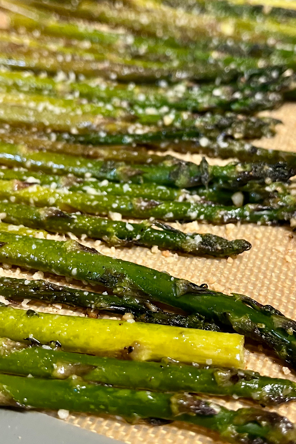 Asparagus has been cooked. This is the closer see a little bit of the asparagus along with some of the cheese and other seasoning