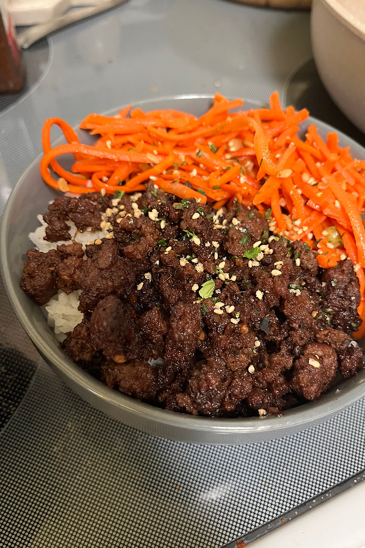 Korean ground beef bowls and see some of the rice as the base with ground beef and carrots taking about the rest of the bowl so Dan topped with rice seasoning special little flex of white of green