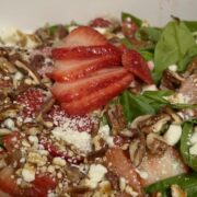 Easy strawberry spinach salad with feta cheese, pecans, and balsamic dressing served in a large bowl.